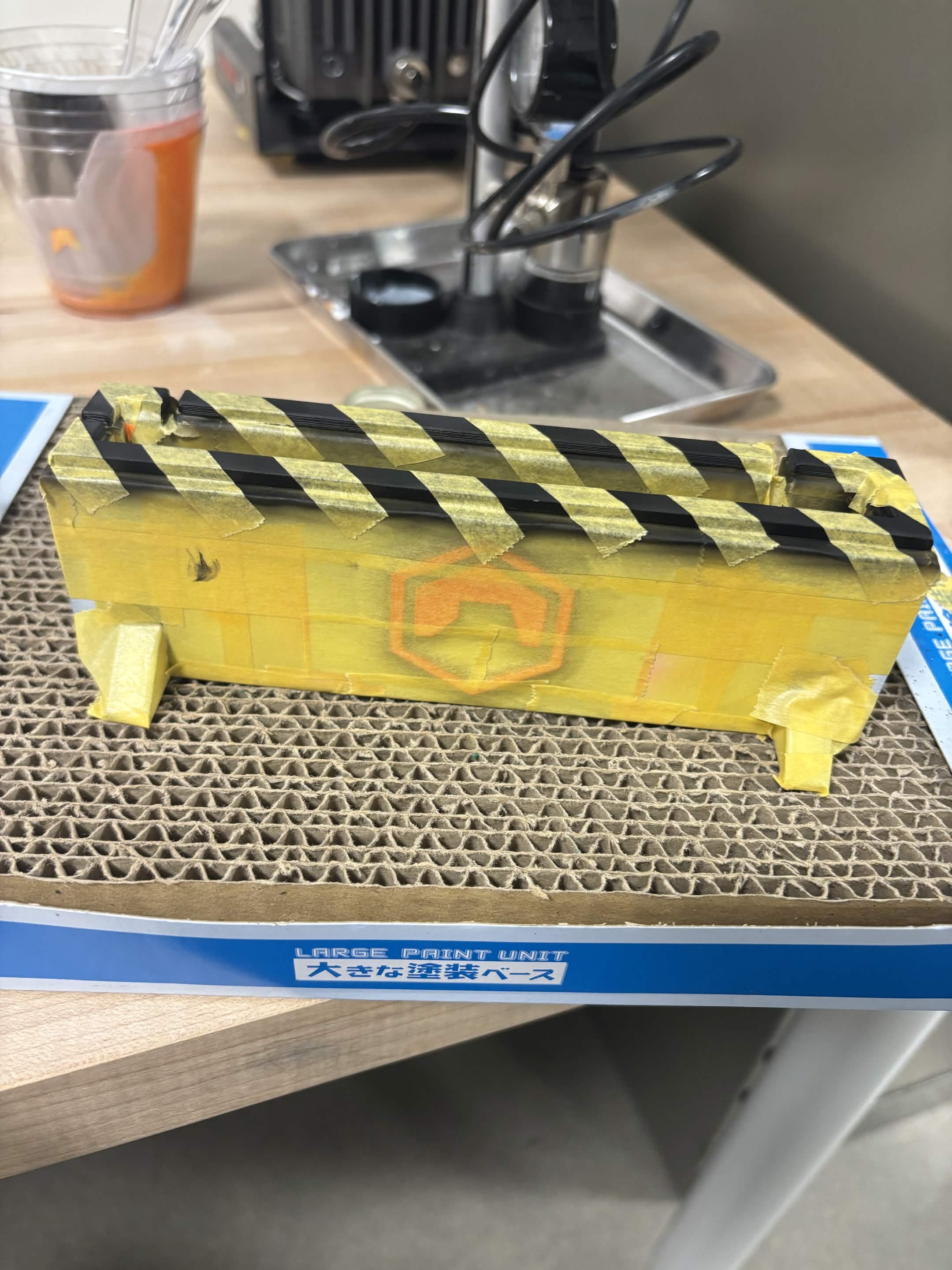 Masking the pendulum enclosure for hazard stripe painting